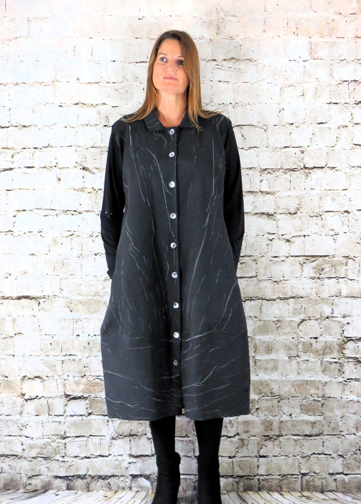 This coat dress is made from a black cotton fabric, with a beautiful marble effect body and black jersey arms . Perfect for any autumn winter occasion, from a wedding, Mother of the Bride, Mother of the Groom, Wedding Guest to a party or everyday wear. This dress will take you from day to night with effortless style and elegance.