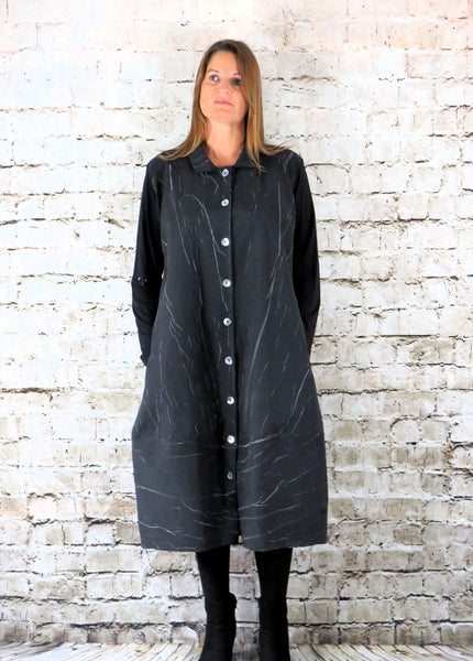 This coat dress is made from a black cotton fabric, with a beautiful marble effect body and black jersey arms . Perfect for any autumn winter occasion, from a wedding, Mother of the Bride, Mother of the Groom, Wedding Guest to a party or everyday wear. This dress will take you from day to night with effortless style and elegance.