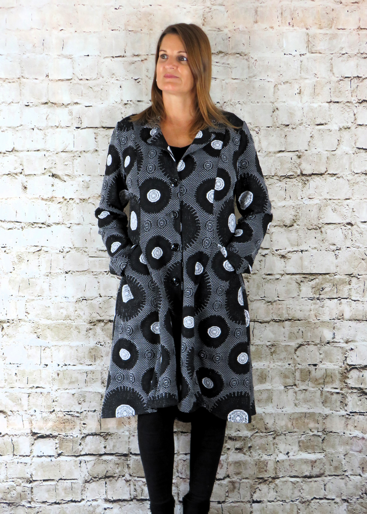 The coat is made from a soft stretch grey jacquard knitted fabric, with a beautiful all over black and white circle design. Perfect for any autumn winter occasion or everyday wear. This coat will take you from day to night with effortless style and elegance.