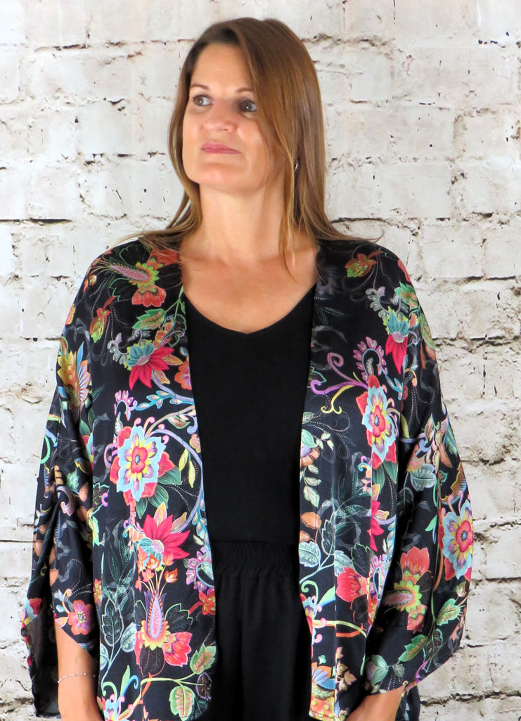 This short kimono is made from a vegan habotai, with a beautiful brightly coloured flower design. Perfect for any autumn winter occasion, from a wedding to a party and everyday wear. This kimono will take you from day to night with effortless style and elegance.