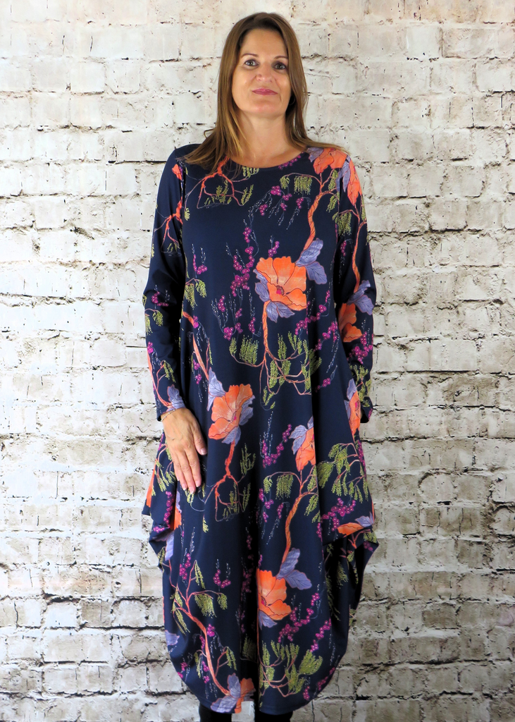 This hitch up dress is made from a soft feel Navy Jersey fabric, with an all over orange and yellow woodland print. The dress has a hitch up hem on both sides, which can be buttoned up or let down for a longer length. Perfect for any autumn / winter occasion from a wedding, mother of the bride, mother of the groom to a party or everyday wear. This dress will take you from day to night with effortless style and elegance. Available in Black, Forest, Navy and Olive.