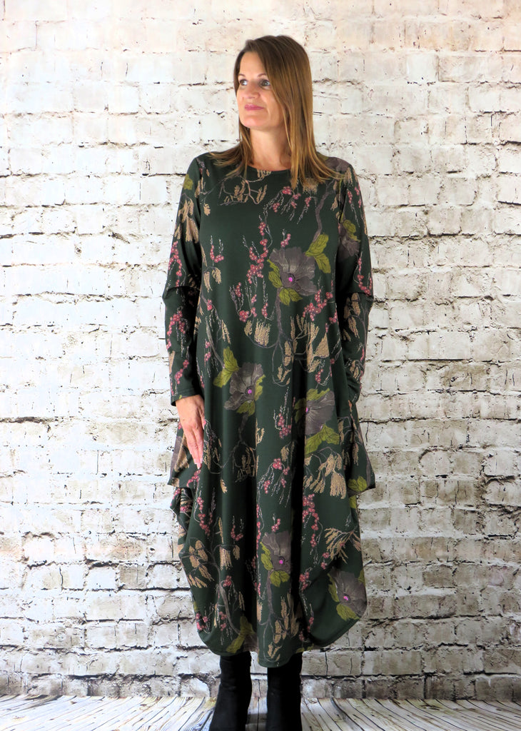 This hitch up dress is made from a soft feel forest Jersey fabric, with an all over green and grey woodland print. The dress has a hitch up hem on both sides, which can be buttoned up or let down for a longer length. Perfect for any autumn / winter occasion from a wedding, mother of the bride, mother of the groom to a party or everyday wear. This dress will take you from day to night with effortless style and elegance. Available in Black, Forest, Navy and Olive.