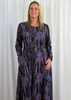 The dress is made from a soft feel jersey fabric with a beautiful, all over purple waterfall print. The dress has a hitch up hem on both sides, which can be buttoned up or let down for a longer length. Perfect for any autumn winter occasion, from a wedding to a party and everyday wear. This dress will take you from day to night with effortless style and elegance.