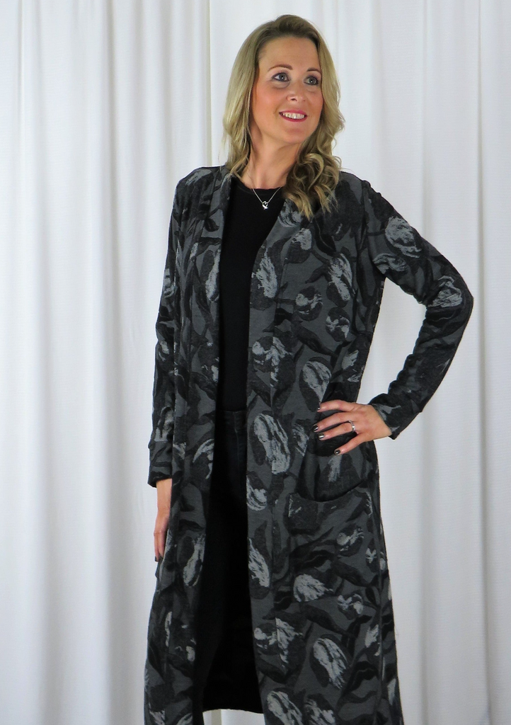 The Cardi Coat is made from a soft grey knitted Jacquard fabric. With an all over grey and black autumnal design. Perfect for any autumn winter occasion, from a wedding to a party and everyday wear. This cardi coat will take you from day to night with effortless style and elegance.