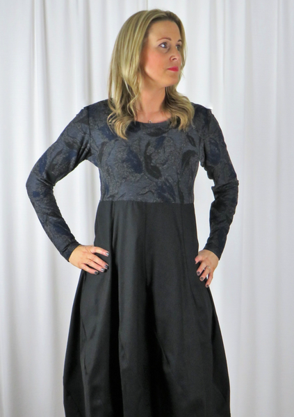 The spiral dress is made from a soft knitted cotton jacquard fabric in a blue and black autumnal design with a black cotton skirt. Perfect for any autumn winter occasion, from a wedding to a party and everyday wear. This dress will take you from day to night with effortless style and elegance.