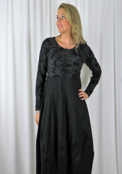 The spiral dress is made from a soft knitted cotton jacquard fabric in a black and grey autumnal design with a black cotton skirt. Perfect for any autumn winter occasion, from a wedding to a party and everyday wear. This dress will take you from day to night with effortless style and elegance.