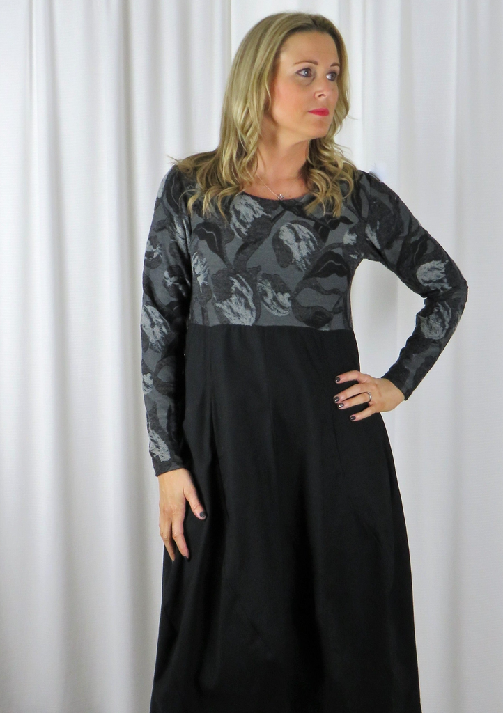 The spiral dress is made from a soft knitted cotton jacquard fabric in a grey and black autumnal design with a black cotton skirt. Perfect for any autumn winter occasion, from a wedding to a party and everyday wear. This dress will take you from day to night with effortless style and elegance.