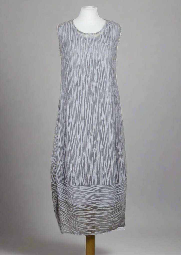 This sleeveless dress is made from a silver sheer fabric with a beautiful all over stripe design, with a soft viscose lining. Perfect for any spring summer occasion, from a wedding - mother of the bride, mother of the groom and wedding guest to everyday wear. This dress will take you from day to night with effortless style and elegance. A matching shrug is available.