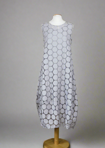 This sleeveless dress is made from a silver sheer fabric with a beautiful all over spot design, and a soft viscose lining. Perfect for any spring summer occasion, from a wedding - mother of the bride, mother of the groom and wedding guest to everyday wear. This dress will take you from day to night with effortless style and elegance. A matching shrug is available.