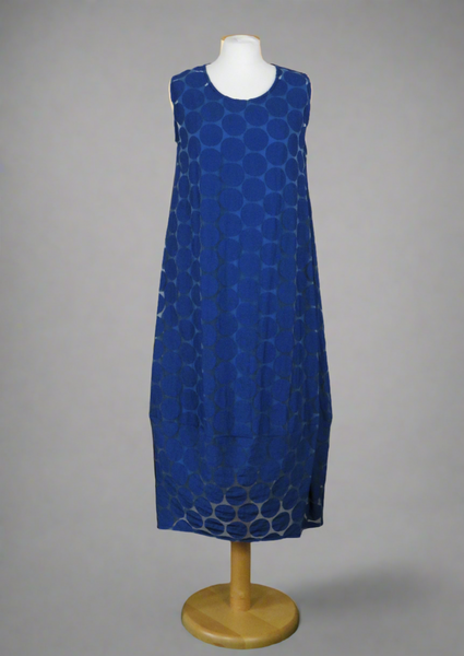 This sleeveless dress is made from a navy sheer fabric with a beautiful all over spot design, and a soft viscose lining. Perfect for any spring summer occasion, from a wedding - mother of the bride, mother of the groom and wedding guest to everyday wear. This dress will take you from day to night with effortless style and elegance. A matching shrug is available.