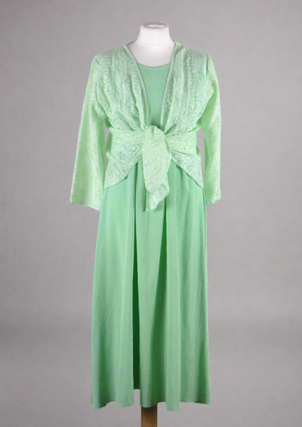 This sleeveless dress is made from a soft green crepe fabric. Perfect for any spring summer occasion, from a wedding - mother of the bride, mother of the groom and wedding guest to everyday wear. This dress will take you from day to night with effortless style and elegance. A matching shrug is available.