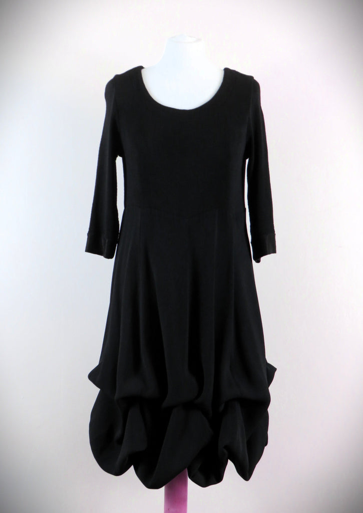 The Fine Rib Multi Hitch Panel Dress is made from a luxurious soft stretch black fabric. The dress has 8 different hitch points or can be worn completely down for a full length look. Perfect for any autumn winter occasion, from a wedding Mother of the Bride, Mother of the Groom, Wedding Guest to a party or everyday wear. This dress will take you from day to night with effortless style and elegance.