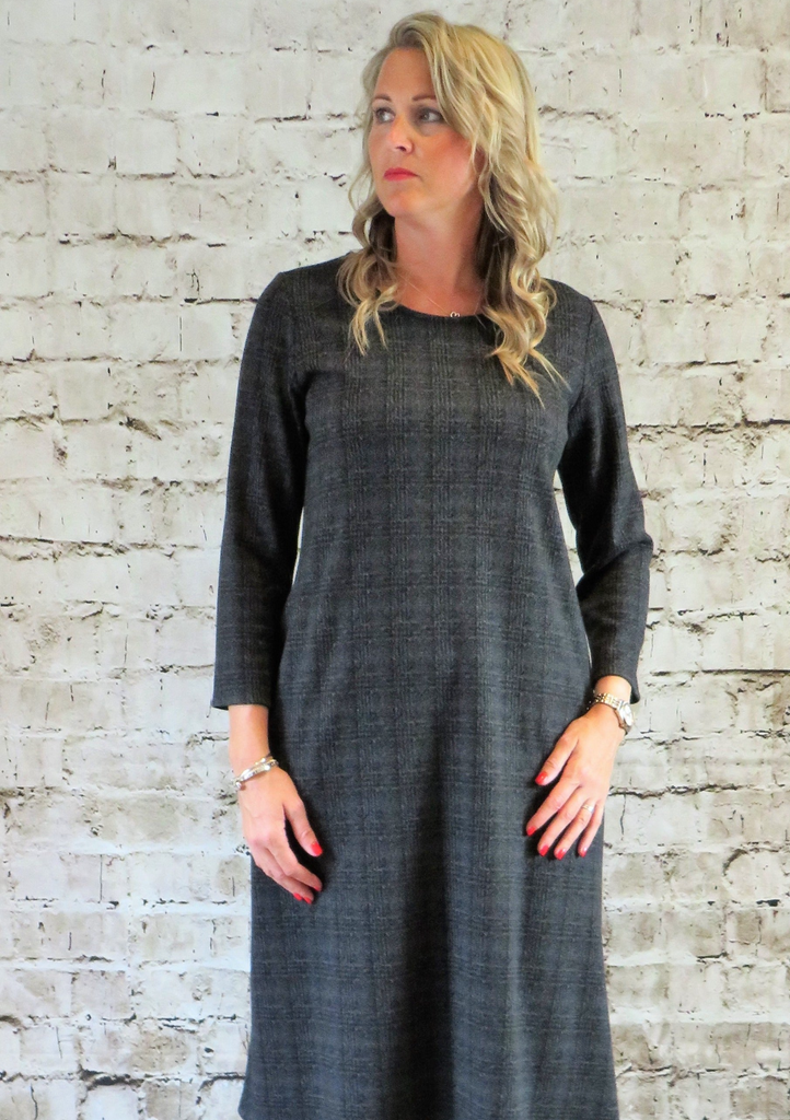 The dress is made from a soft stretch grey cotton knitted fabric, with a beautiful all over check design. Perfect for any autumn winter occasion or everyday wear. This dress will take you from day to night with effortless style and elegance.