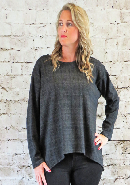 The wide top is made from a soft stretch grey knitted fabric, with a beautiful all over check design. Perfect for any autumn winter occasion or everyday wear. This top will take you from day to night with effortless style and elegance.