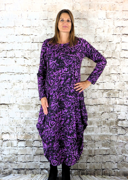 This hitch up dress is made from a soft feel cerise Jersey fabric, with an all over rose print. The dress has a hitch up hem on both sides, which can be buttoned up or let down for a longer length. Perfect for any autumn / winter occasion from a wedding, mother of the bride, mother of the groom to a party or everyday wear. This dress will take you from day to night with effortless style and elegance. Available in Aqua, Cerise and White.