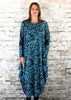 This hitch up dress is made from a soft feel aqua Jersey fabric, with an all over rose print. The dress has a hitch up hem on both sides, which can be buttoned up or let down for a longer length. Perfect for any autumn / winter occasion from a wedding, mother of the bride, mother of the groom to a party or everyday wear. This dress will take you from day to night with effortless style and elegance. Available in Aqua Cerise and White.